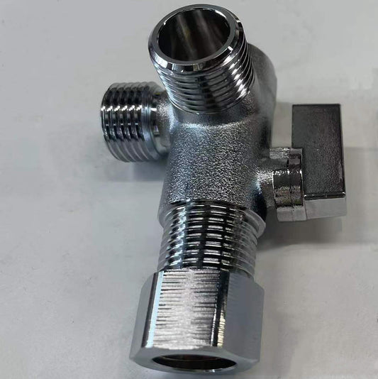 Metallic T-shaped valve on a light gray background